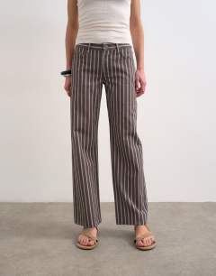 Model wearing Ember low rise straight leg jean in chocolate stripe