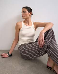 Model wearing Ember low rise straight leg jean in chocolate stripe