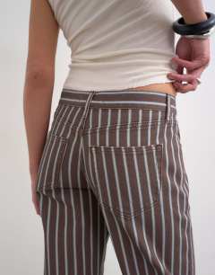 Model wearing Ember low rise straight leg jean in chocolate stripe
