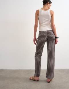 Model wearing Ember low rise straight leg jean in chocolate stripe