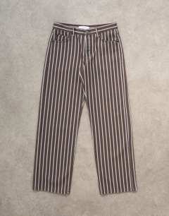 Model wearing Ember low rise straight leg jean in chocolate stripe