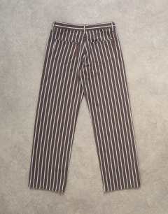 Model wearing Ember low rise straight leg jean in chocolate stripe