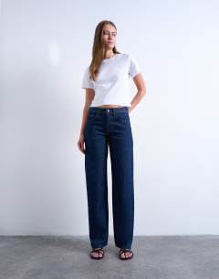 Model wearing Ember low rise straight leg jean in indigo rinse