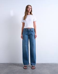 Model wearing Ember low rise straight leg jean in mid blue