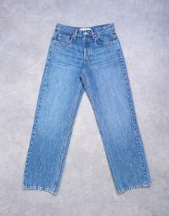 Model wearing Ember low rise straight leg jean in mid blue