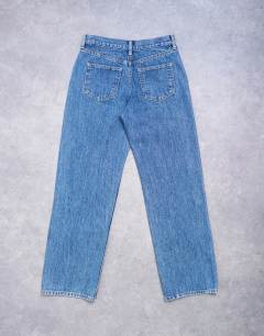 Model wearing Ember low rise straight leg jean in mid blue
