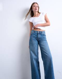 Model wearing Ember low rise straight leg jean in vintage blue