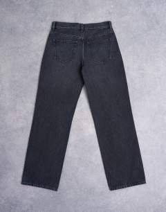 Model wearing Ember low rise straight leg jean in washed black