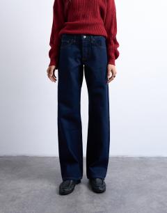 Model wearing Ember low rise straight leg jeans in indigo rinse