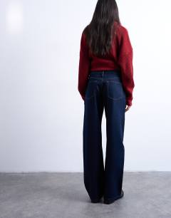 Model wearing Ember low rise straight leg jeans in indigo rinse