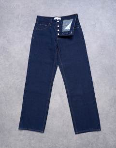 Model wearing Ember low rise straight leg jeans in indigo rinse