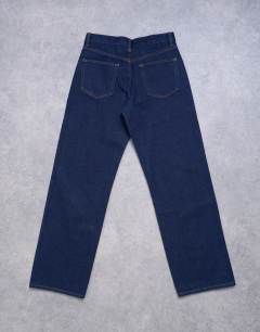 Model wearing Ember low rise straight leg jeans in indigo rinse