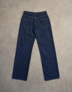 Model wearing Ember low rise straight leg jeans in indigo rinse