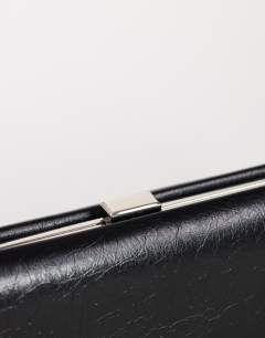 Model wearing Ember small envelope clutch bag in black