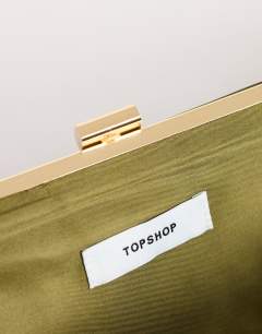 Model wearing Ember small envelope satin clutch bag in green
