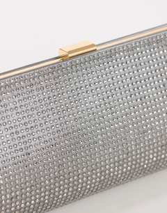 Model wearing Ember small envelope satin clutch bag in silver diamante