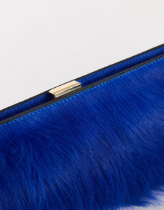Model wearing Ember small hair on real leather envelope clutch bag in cobalt