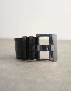 Model wearing Embossed real leather chunky leather belt in black