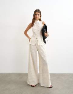 Model wearing Embroidered lace high neck sleeveless tank co-ord in cream