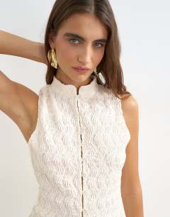 Model wearing Embroidered lace high neck sleeveless tank co-ord in cream