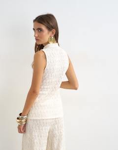 Model wearing Embroidered lace high neck sleeveless tank co-ord in cream