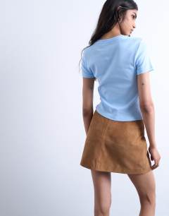Model wearing Embroidered New York baby tee in light blue