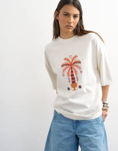Model wearing Embroidered Paradiso oversized t-shirt in white