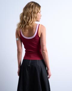 Model wearing Embroidered Roma contrast rib vest in burgundy