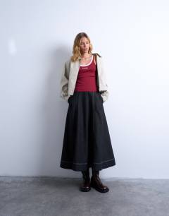 Model wearing Embroidered Roma contrast rib vest in burgundy