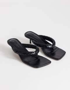 Model wearing Emily pin heel woven toe thong sandal in black
