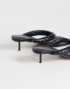 Model wearing Emily pin heel woven toe thong sandal in black