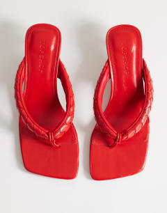 Model wearing Emily pin mid heel woven toe thong sandal in red
