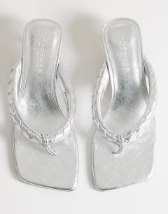 Model wearing Emily pin mid heel woven toe thong sandal in silver