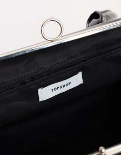 Model wearing Emma medium clasp shoulder bag in black