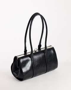 Model wearing Emma medium clasp shoulder bag in black