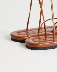 Model wearing Emma strappy flat sandal in tan