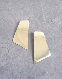 Model wearing Emmey statement stud earrings in gold