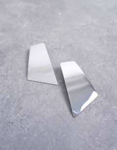 Model wearing Emmey statement stud earrings in silver