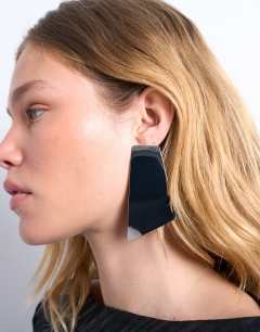 Model wearing Emmey statement stud earrings in silver