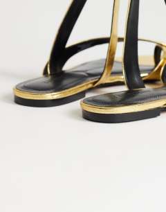 Model wearing Erika flat sandal in gold