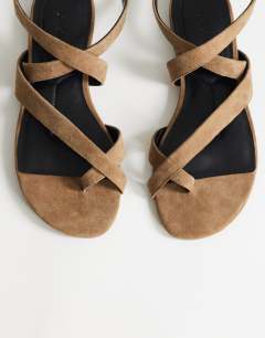 Model wearing Erika real suede flat sandal in taupe