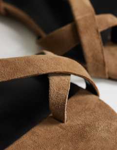 Model wearing Erika real suede flat sandal in taupe