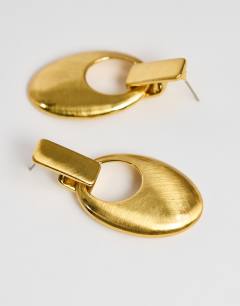 Model wearing Esme door-knocker earrings in gold brushed