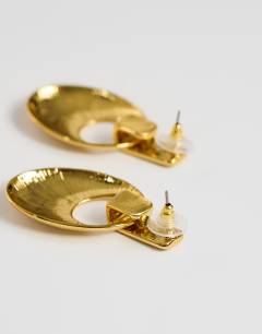 Model wearing Esme door-knocker earrings in gold brushed