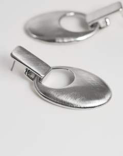 Model wearing Esme door-knocker earrings in silver brushed
