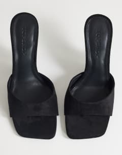 Model wearing Esme mule with clear wedge heel in black