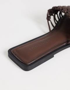 Model wearing Eve woven flat sandal in chocolate