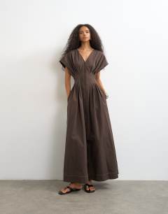 Exaggerated shoulder cinched pintucked waist maxi dress in chocolate brown with contrast topstitching