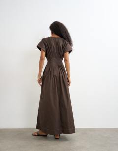 Model wearing Exaggerated shoulder with cinched pintuck waist in chocolate