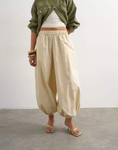 Model wearing Extreme poplin  pull on balloon trouser in yellow